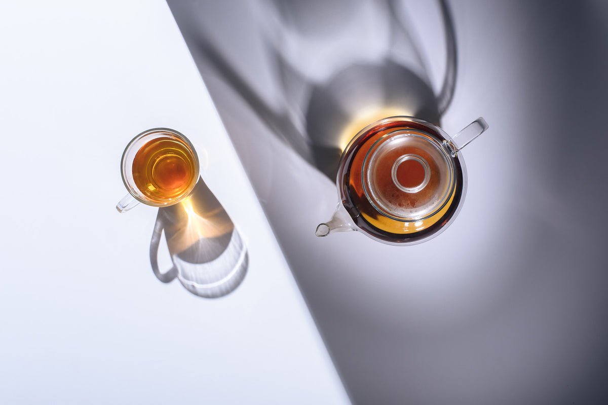 Glass teapot and teacup overhead shot