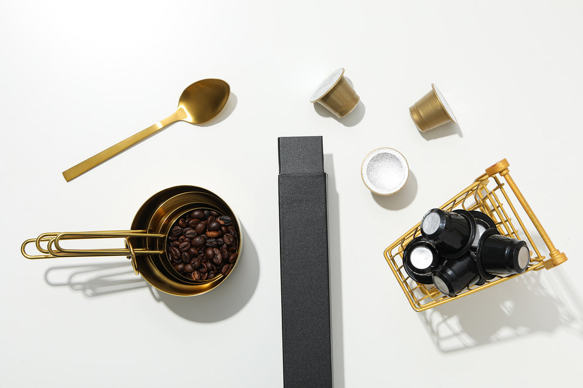 espresso portafilter with wooden-handle tamper and fine steel puck screen on marble counter, soft morning window light, 