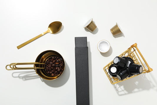 espresso portafilter with wooden-handle tamper and fine steel puck screen on marble counter, soft morning window light, 