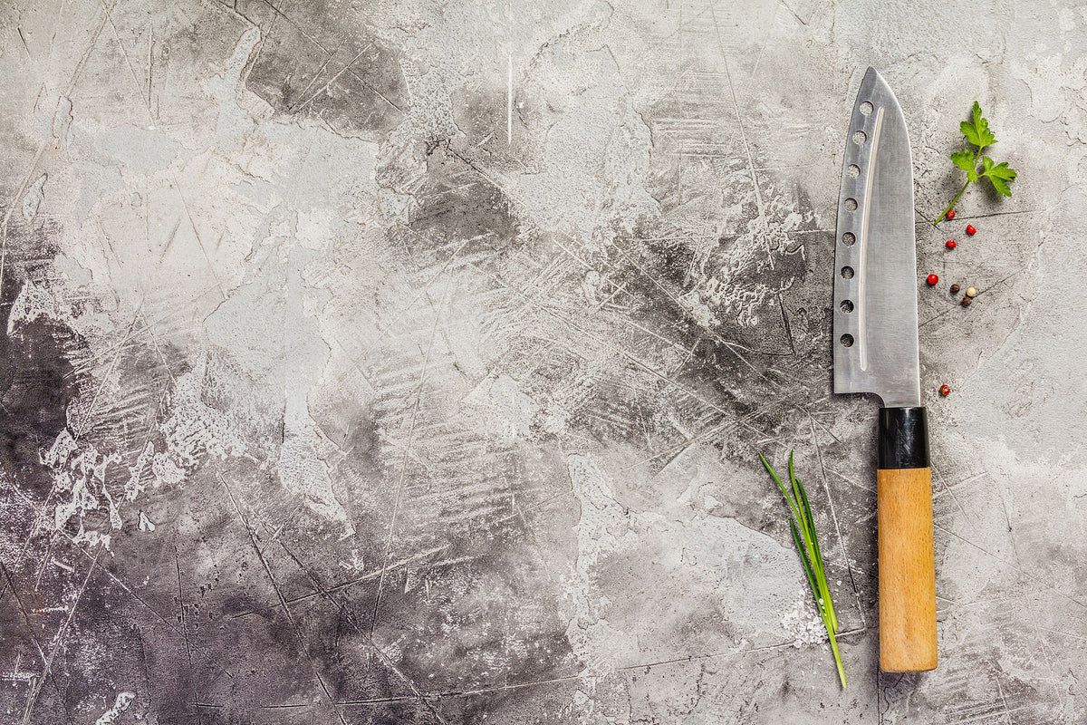 Japanese kitchen knife on a stone surface