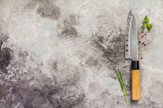 Japanese kitchen knife on a stone surface