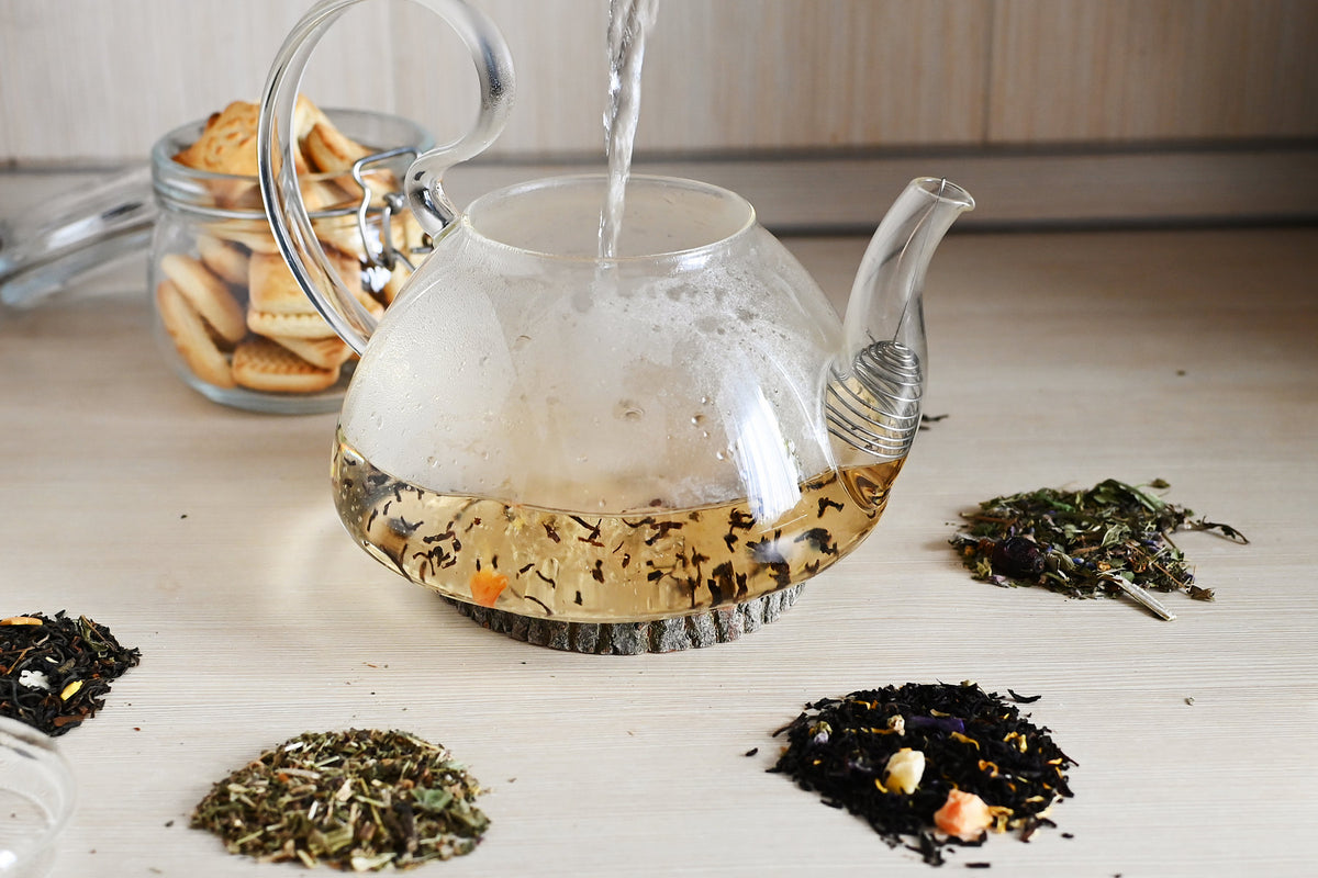 Glass teapot with boiling water poured in on a kitchen counter