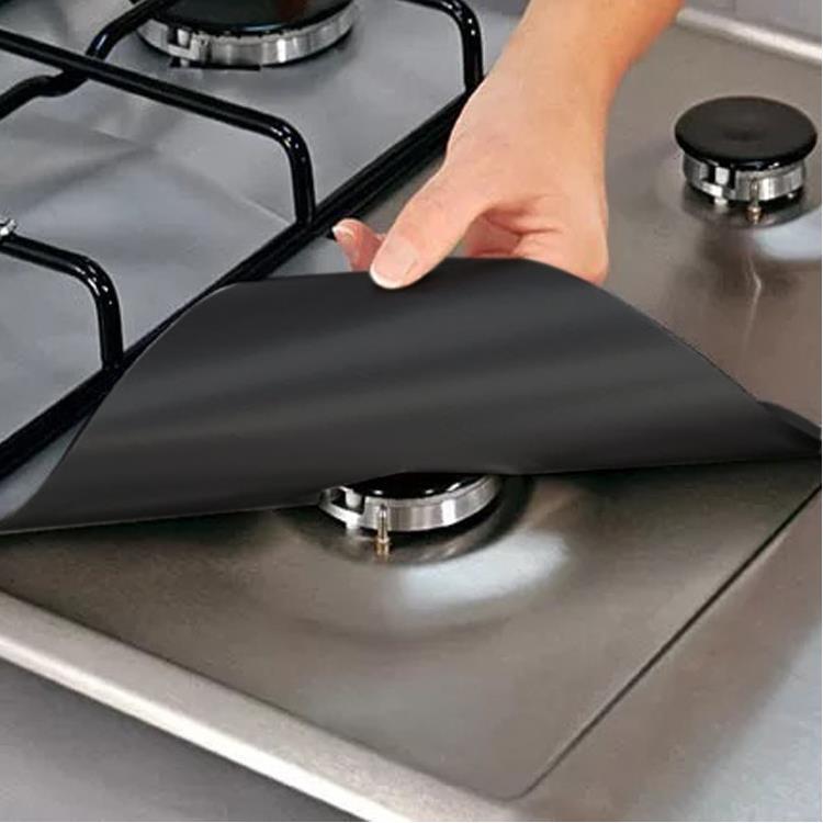 Black gas hob burner liner laid under a pan support