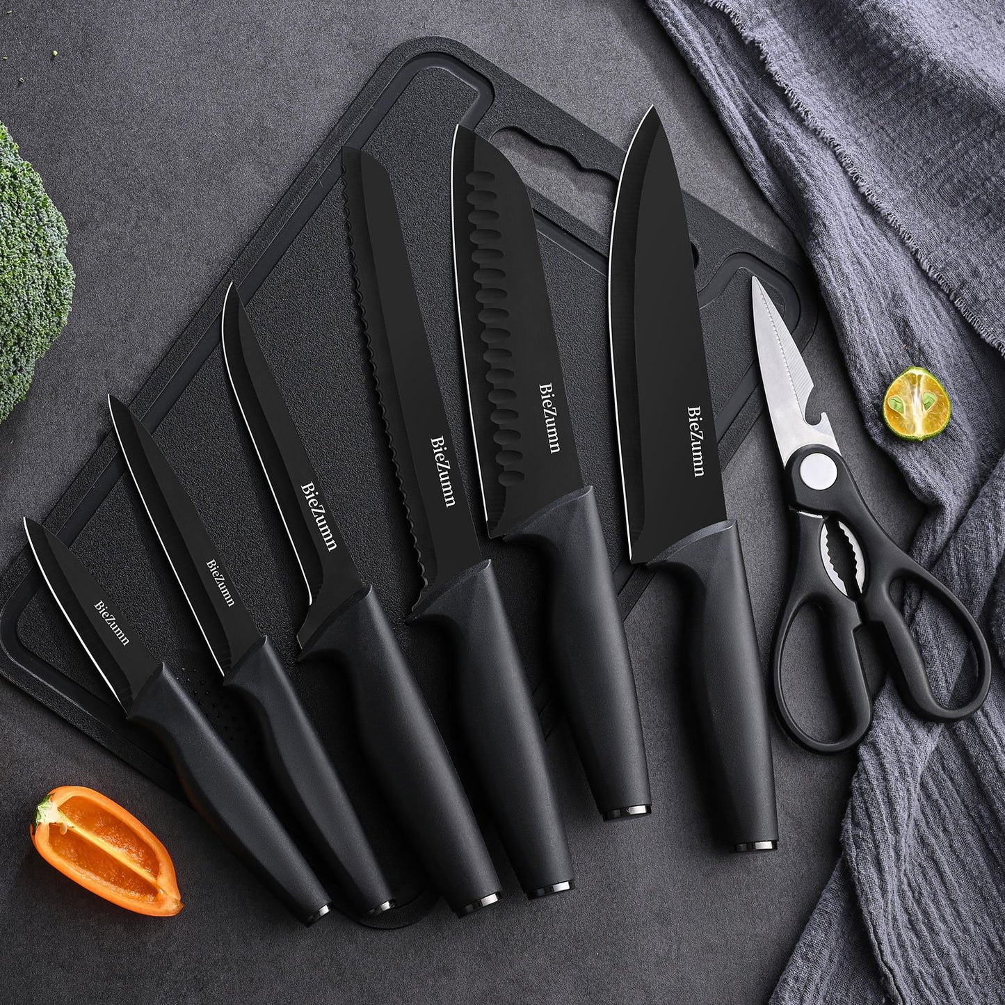 Full 16-piece knife set laid flat: chef, bread, utility, steak knives, shears and paring knife