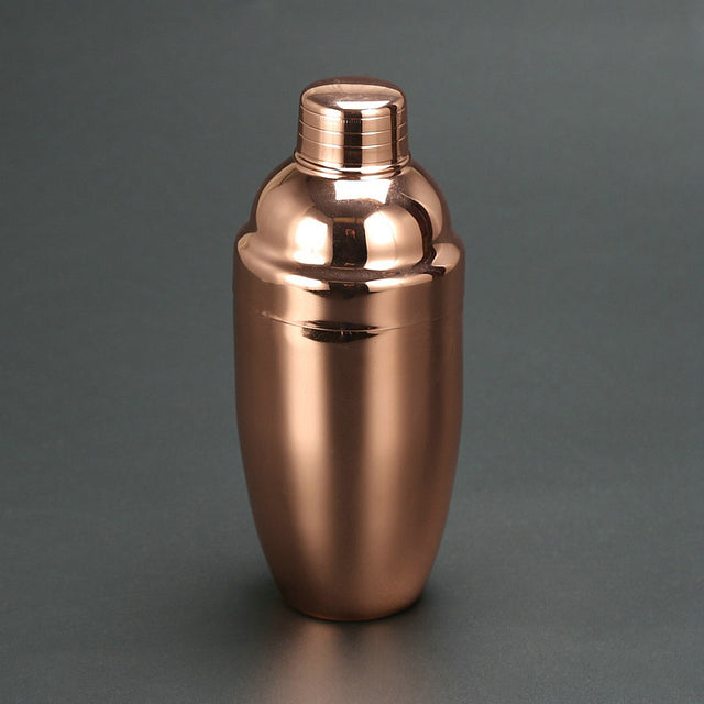 Elegant stainless steel cocktail shaker on a modern bar cart