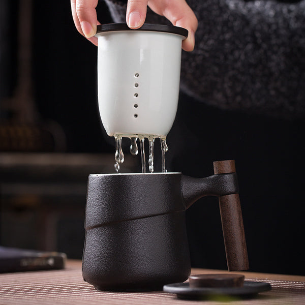 Wudy Kitchen Wudy Ceramic Wooden Handle Tea Cup — black ceramic, wooden handle detail — close-up detail on walnut surface